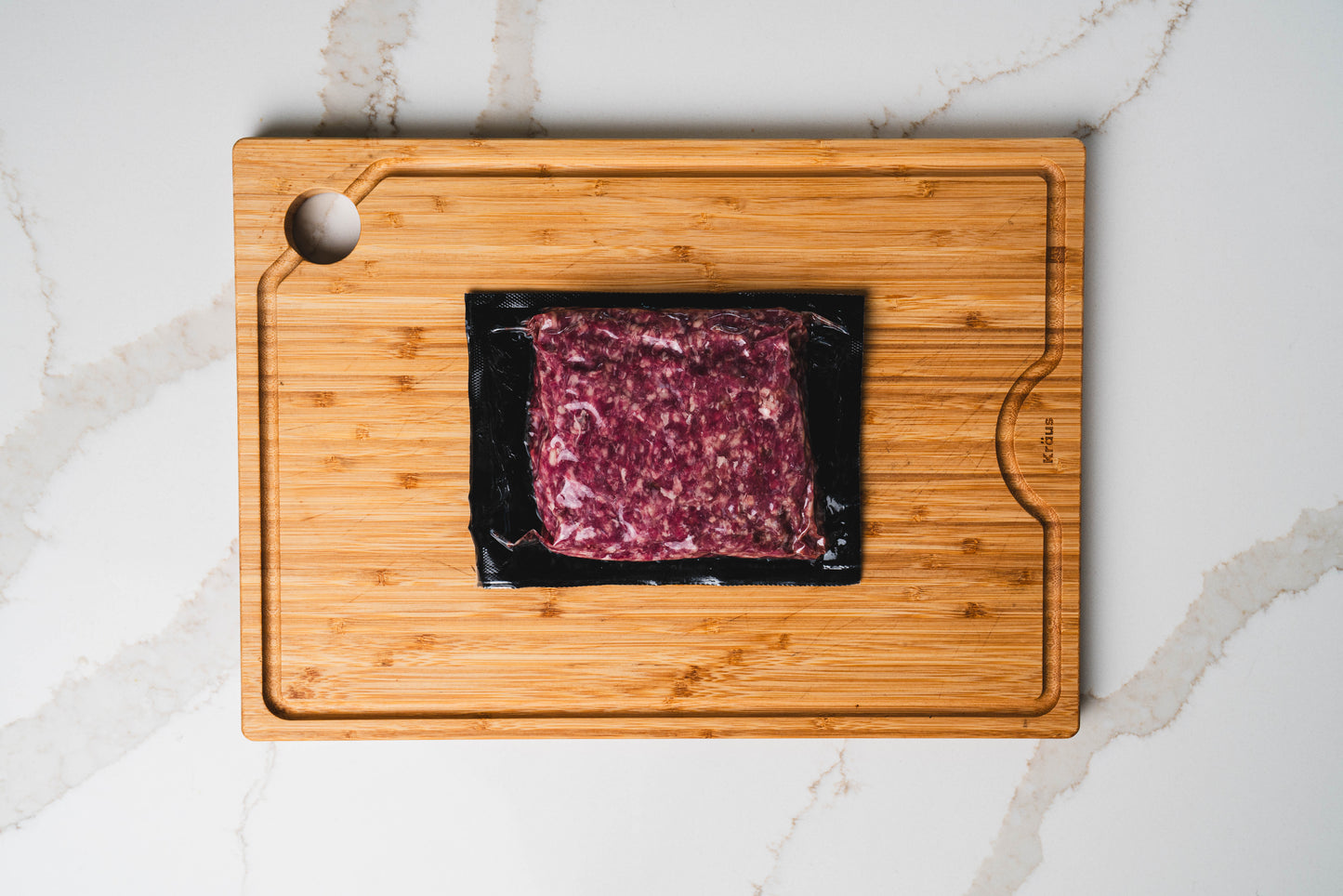 Raw nutrient-optimized ground beef on wooden board