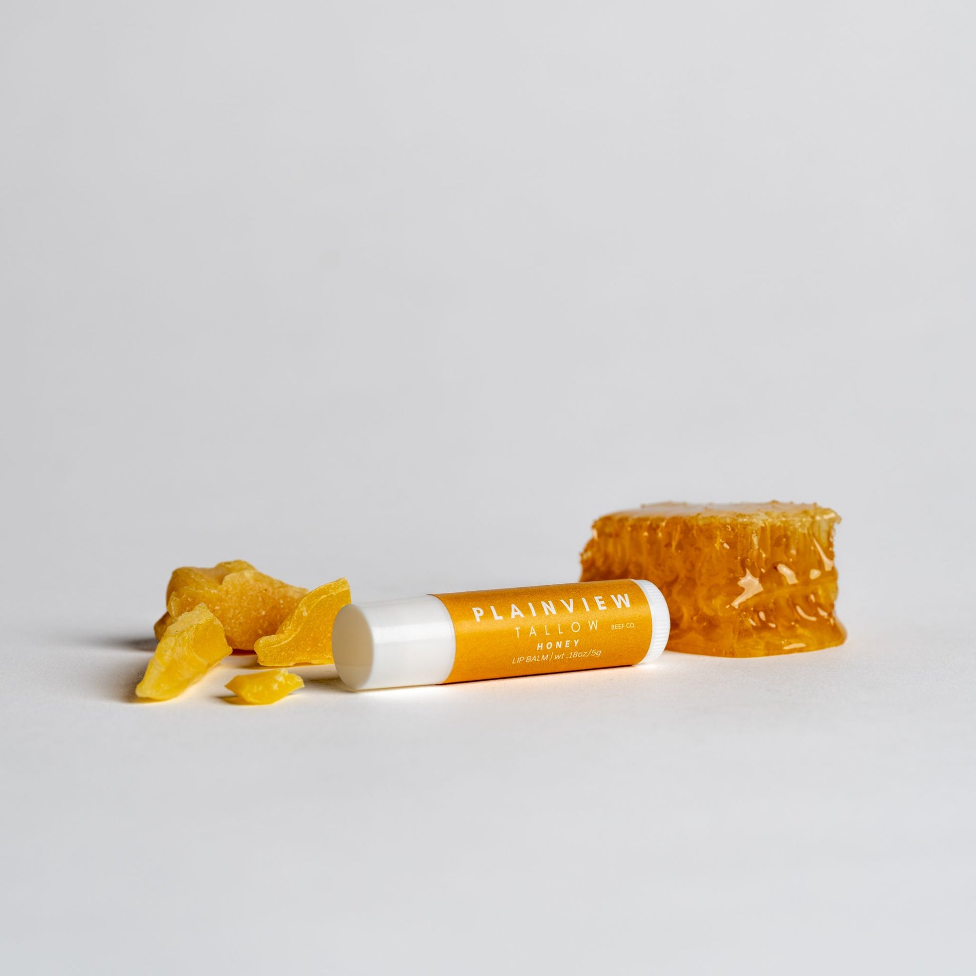 Unscented tallow honey lip balm with honey on the side