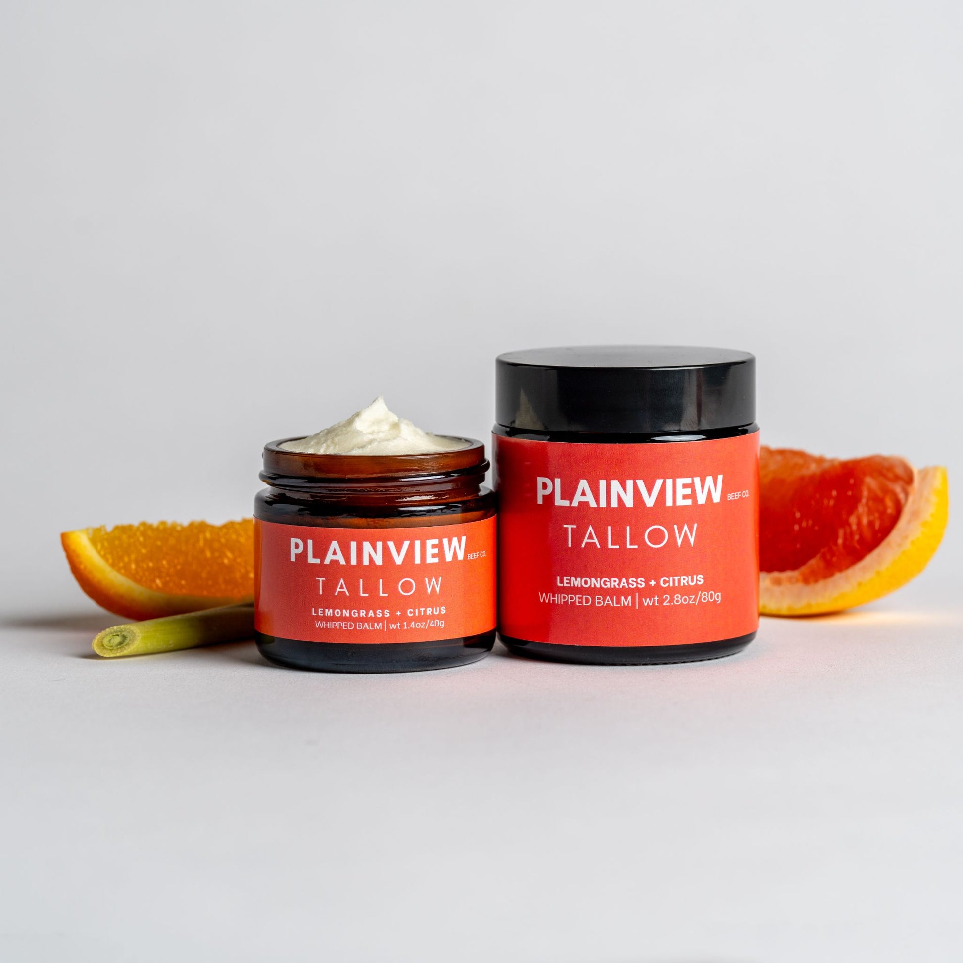 lemongrass and citrus tallow whipped balm jars with citrus fruits