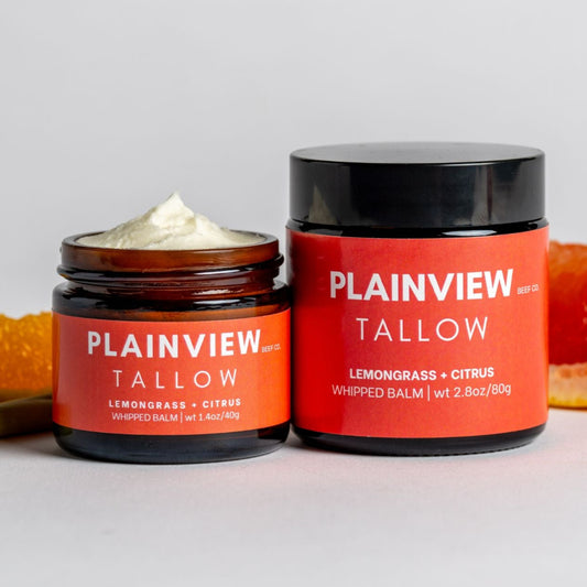 lemongrass and citrus tallow whipped balm jars with citrus fruits