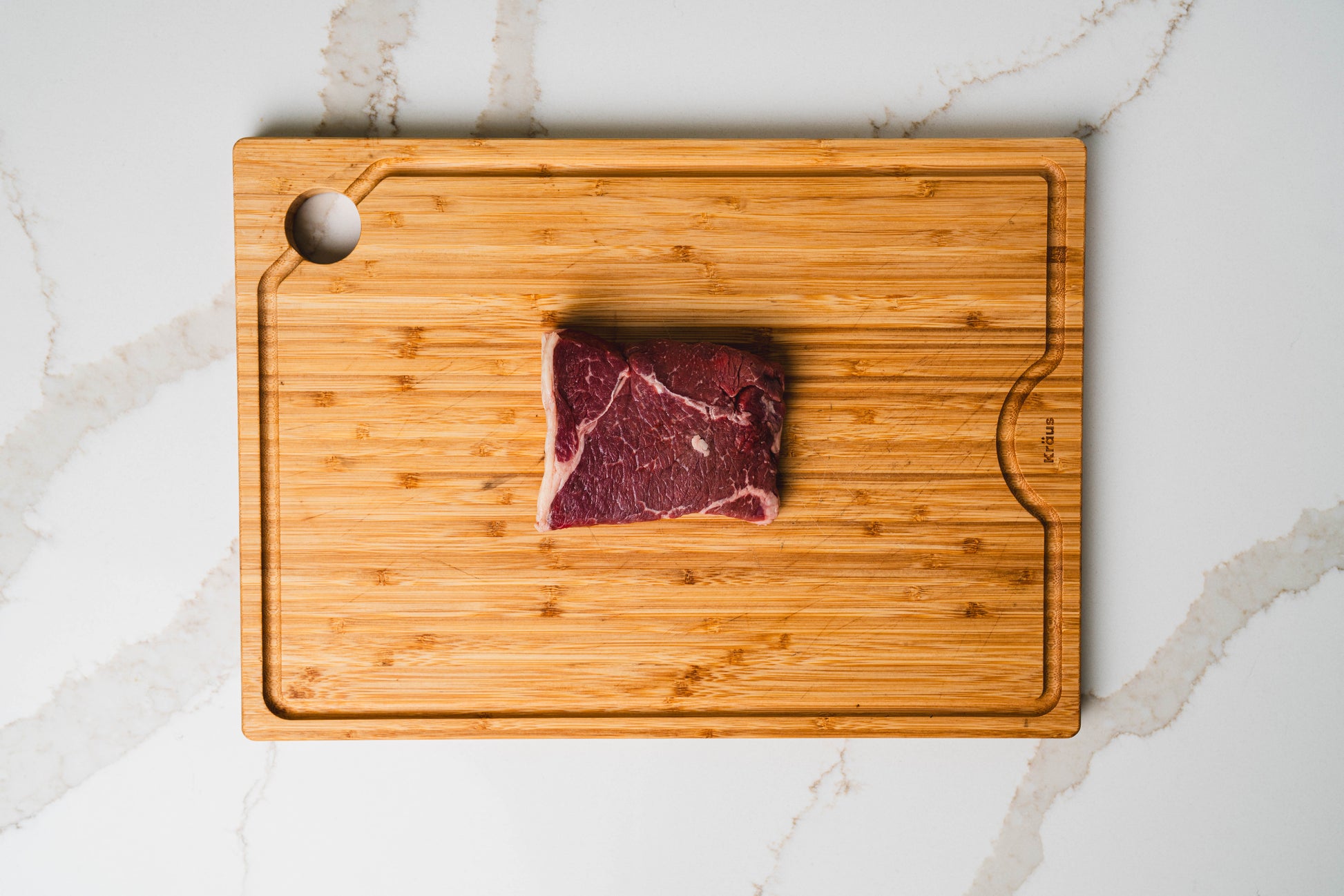 Raw nutrient-optimized sirloin tip on wooden board