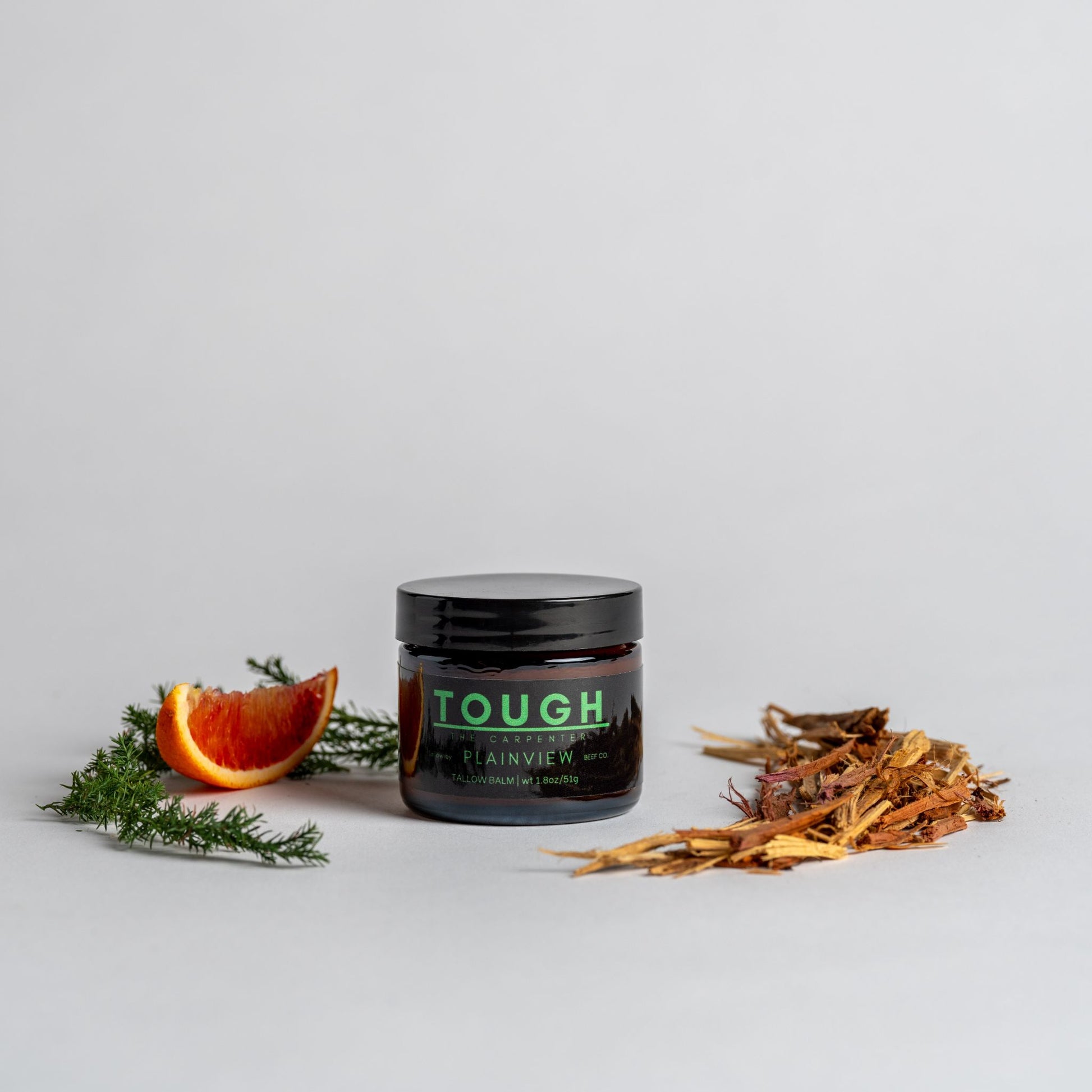 Jar of Tough Tallow Balm The Carpenter with cedarwood, black spruce and orange slice