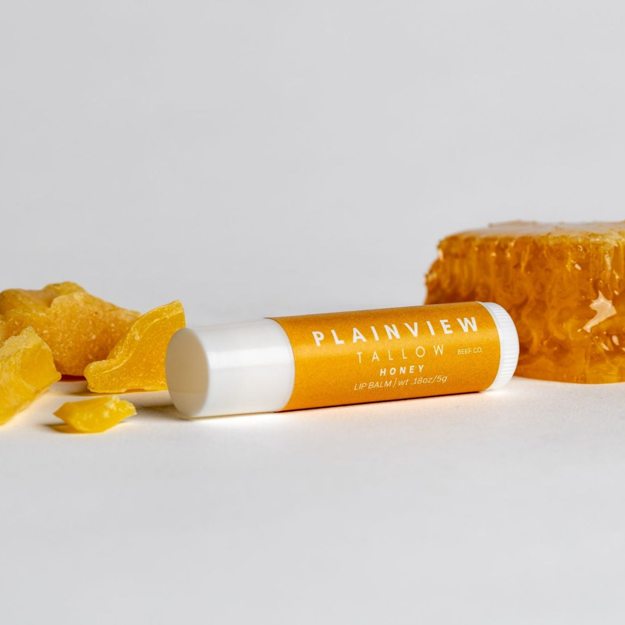 Unscented tallow honey lip balm with honey on the side