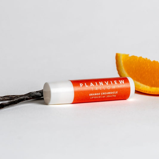 Orange creamsicle lip balm with an orange slice and vanilla bean