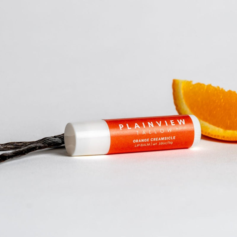 Orange creamsicle lip balm with an orange slice and vanilla bean